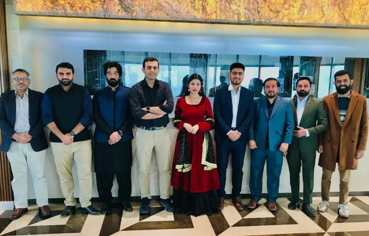 The leadership team standing together in the office lobby