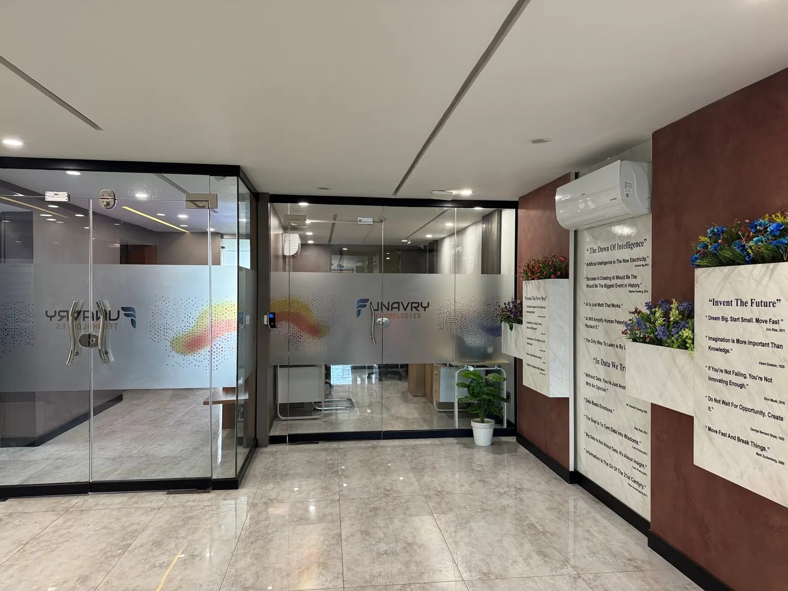 The entrance to the Funavry office, with glass meeting rooms and a quote wall
